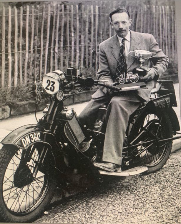 0_British-Army-Captain-Tom-Moore-poses-with-trophies-on-a-motorcycle.jpg